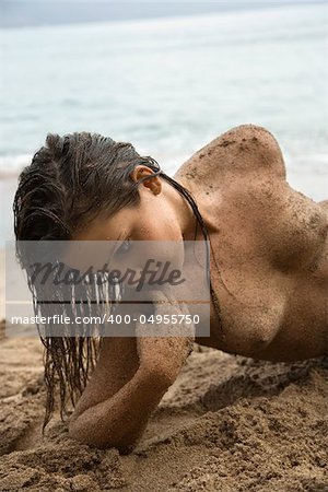 Sexy Caucasian young adult topless woman at beach.