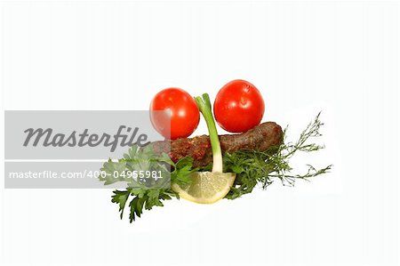 Kebab, tomatoes, onion, parsley and lemon on a white background