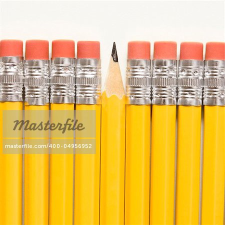 Even row of eraser ends of pencils except for one that has the pointed end up.