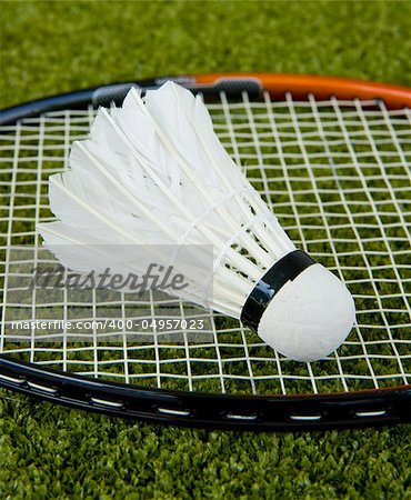 Badminton racquet and a shuttlecock on the grass