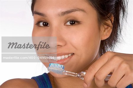 Teenager girl brushes her teeth