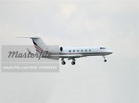 Small charter jet approaching airport for landing