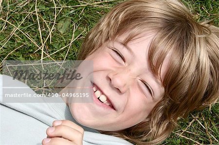 Little brother being tickled while rolling in the grass