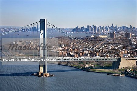 Aerial view of New York City's Verrazano-Narrow's bridge with Manhattan skyline.