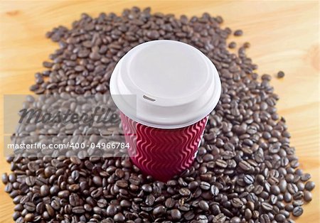 Take away coffee cup with roasted coffee background