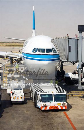 Aircraft tow tractor standing by for push back.