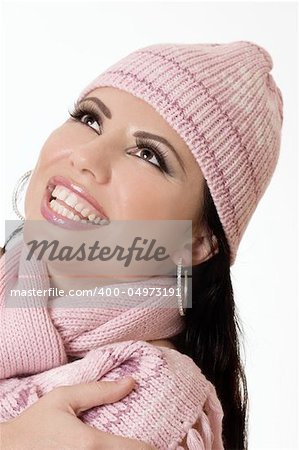 Attractive brunette smiling and looking fabulous in pink winter woollens