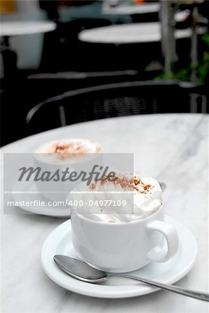 Two cups of specialty coffee on a table in a cafe