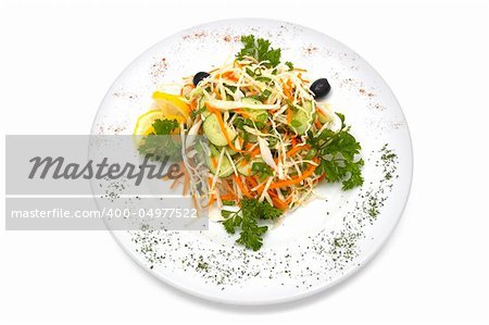 Salad made with fresh cabbage, cucumber, carrot, parsley. Black olives and slice of lemon added.