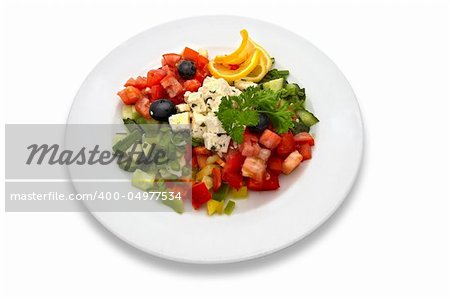 Salad made of fresh tomatoes, feta cheese, cucumbers, red peppers, lemon slices, olives and parsley.