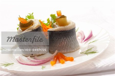 Phil of herring with vegetables on the plate