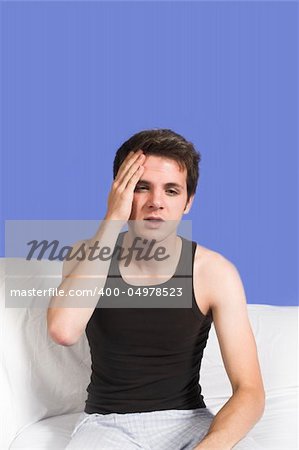 man with headache over blue background