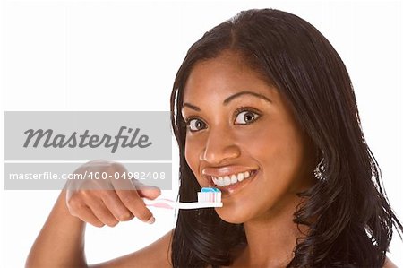 Portrait of black woman holding toothbrush with blue toothpaste and smiling