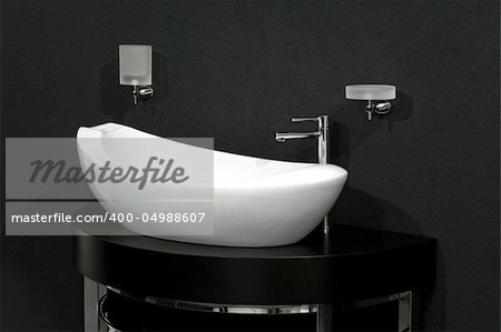 Oval shape white basin over black wall