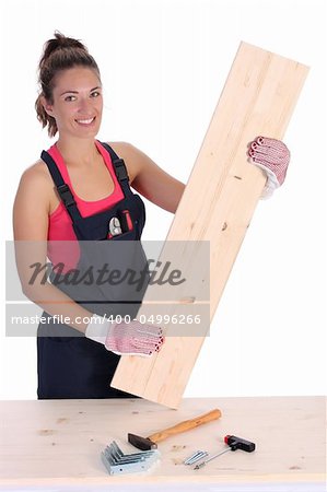 woman carpenter holding wooden plank on white background