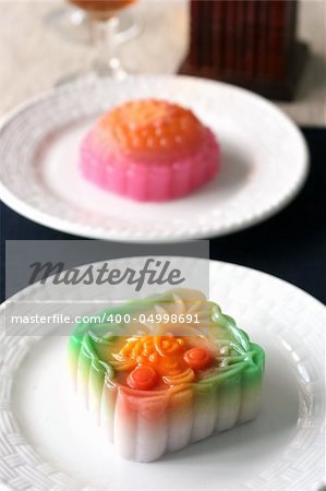 Colorful fruit flavored mooncakes with goldfish patterns signifying prosperity and wealth