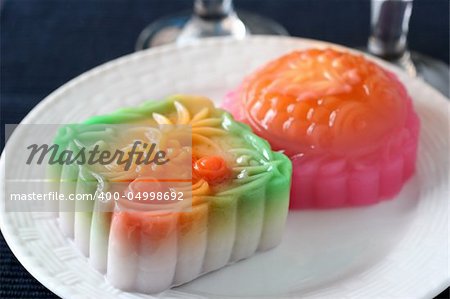 Colorful fruit and egg flavored mooncakes with goldfish patterns signifying prosperity and wealth