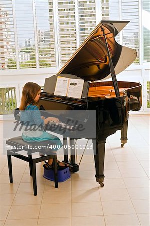 little girl playing the grand piano