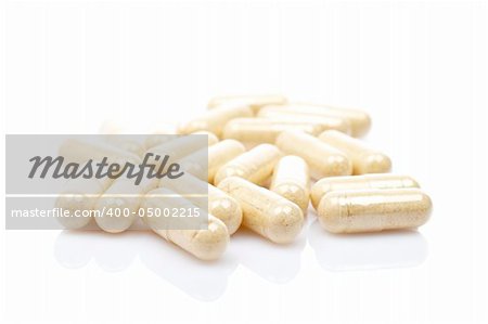 Capsules reflected on white background with shallow DOF