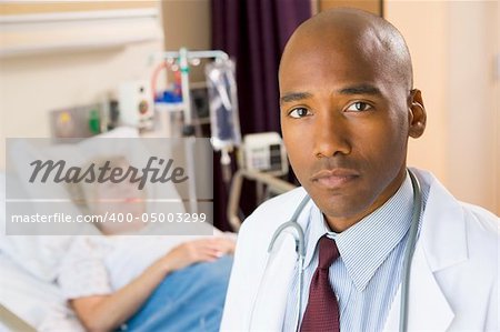 Doctor Looking Serious In Hospital Room,Senior Woman Lying In Ho