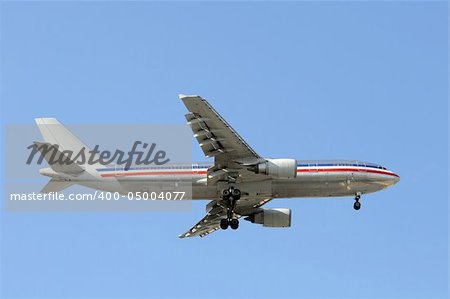Silver colored passenger jet airplane in flight