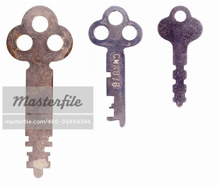 Three old rusty worn keys isolated on a white background.