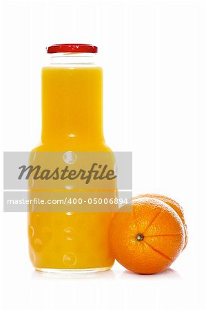 Orange juice bottle reflected on white background. Shallow depth of field