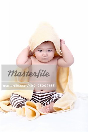 bright portrait of adorable baby wrapped in towel