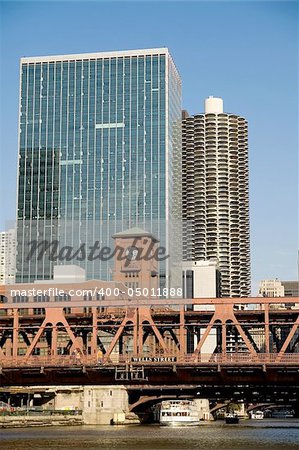 Double decker bridge over Chicago river in downtown Chicago with modern office and condominium buildings in background