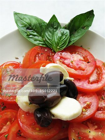 close up photo of italian caprese tomato mozzarella olive salad