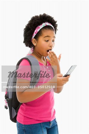 African American girl with backpack looking at cell phone with surprised expression.