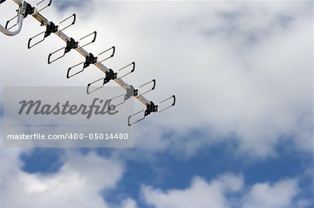 detail from aerial analoque television antena with cloudy sky background