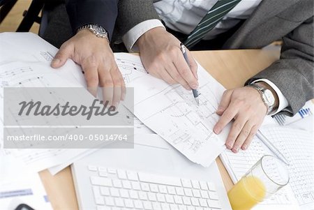 business meeting detail hands over a blueprint