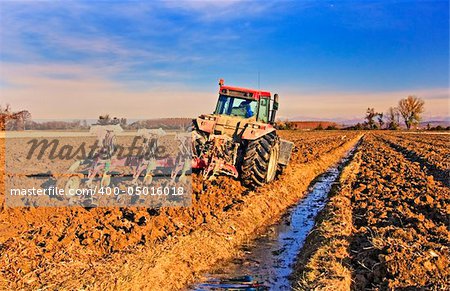 Tractor preparing the field before seeding