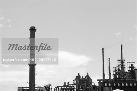 Factory with smoke stacks against blue sky