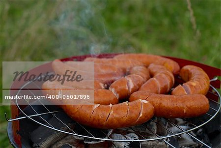 Sausages on Barbecue Grill being cooked . BBQ time.
