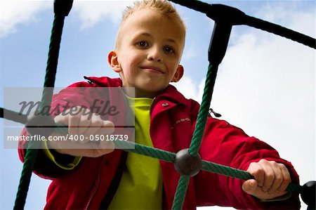 A young boy playing at the playground.