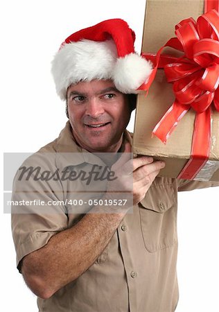 a delivery man in a Santa hat listening to a gift he's supposed to deliver