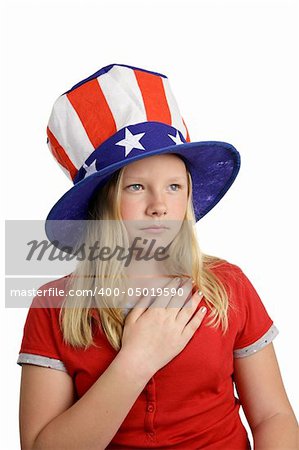 A pretty American girl in a stars and stripes hat, solemnly saying the pledge of allegiance.  Isolated on white.