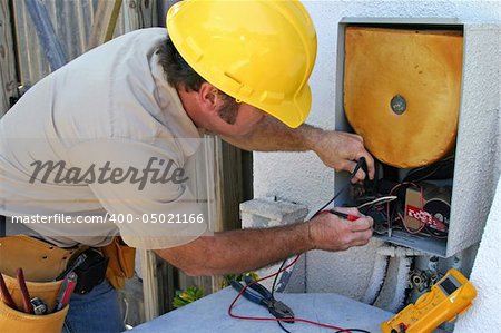 An air conditioning tech working on a heat recovery unit.