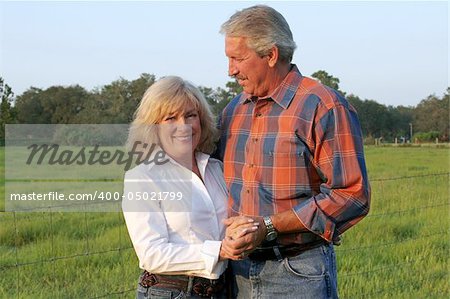 a good-looking, mature couple on a farm