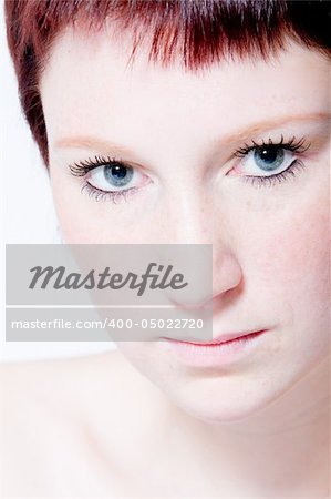 Studio portrait of a young woman with short hair making eye contact