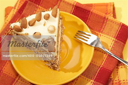 piece of almonds cake on the yellow plate