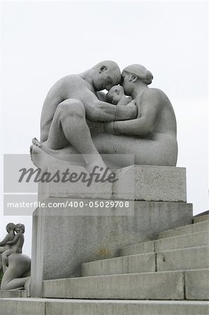 Sculpture of a couple with child at Vigeland Sculpture Park, Oslo Norway.  (Frognerparken)