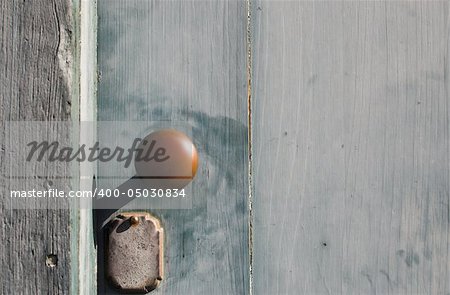 An antique doorknob on an antique door of a historic building.