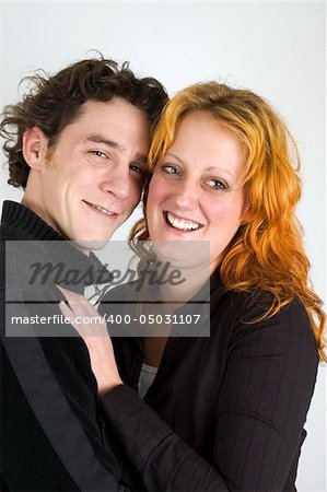 Two young people in love, laughing and holding each other.