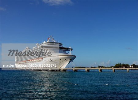 Luxury cruise ship docked at exotic island destination
