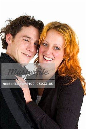 Two young people in love, laughing and holding each other. Isolated on white.