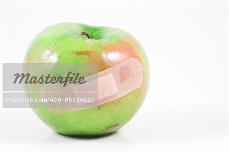 A bruised apple with a band-aid.