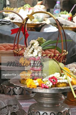 Buddhist shrine offering in Thailand with fruits and flower garlands